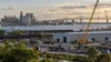 An industrial construction district beside a Louisiana waterway in late-afternoon light