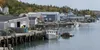 A working waterfront with warehouses and small boats in coastal Maine
