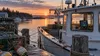 A Maine lobster boat with traps and a generic navigation display at dawn