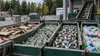 Sorted cardboard, glass, metal cans and plastic containers at an unbranded municipal recycling facility in Maine