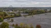 Illustrative aerial view of a closed amusement park and empty parking area in early autumn