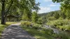 A paved loop trail, picnic pavilion and restored stream in a leafy public park