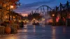 A generic New England amusement park midway decorated for fall at dusk