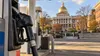 Conceptual editorial image of a fuel nozzle with the Massachusetts State House in the distance.