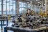 Precision automotive driveline components arranged inside a modern automated factory near a Great Lakes waterfront