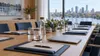 An empty conference table prepared for an international business meeting with a Minnesota city skyline beyond the windows.