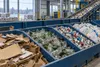 Sorted cardboard, glass, aluminum and plastic at a generic materials recovery facility.