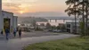 Workers arrive at a generic Mississippi industrial and office corridor beside a river at dawn.