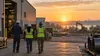 An industrial worksite and construction equipment in warm morning light, representing Mississippi employment.
