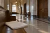 Empty courthouse corridor with blank map papers on a wooden bench