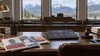 Abstract political mailers, a laptop and a gavel on a courtroom desk with mountain views