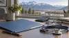 Unbranded health-benefits materials, calculator and stethoscope on a desk overlooking Montana mountains