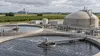 Illustrative view of a modern wastewater treatment and anaerobic digestion facility in Nebraska farm country.