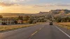 Illustrative Nebraska highway approaching a small town with lodging and restaurants
