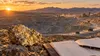 Open-pit gold mine and financial ledger in Nevada desert terrain