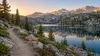 Conceptual Nevada alpine backcountry trail beside a mountain lake