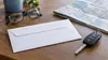 AI-generated editorial image of a sealed envelope, car keys, reading glasses and a road map representing a driver-record notice.