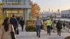 Workers and commuters approach a New Jersey office and light-industrial complex on an early autumn morning.