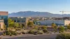 Illustrative view of a New Mexico commercial and light-industrial district with desert landscaping and distant mountains.