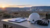 Safety inspection equipment on a table before a generic nuclear research facility in the New Mexico desert.
