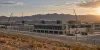 Editorial rendering of a large data center campus under construction in a southern New Mexico desert landscape
