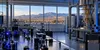 Illustrative quantum research laboratory overlooking New Mexico's high desert and distant mountains.