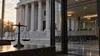 Federal courthouse seen beside an empty immigration court waiting area and a balanced justice scale.