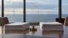 Legal filings on a conference table overlooking an offshore wind farm