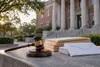 Conceptual courthouse exterior with a gavel, blank folders and ballot envelopes