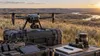 Modern public-sector drone and sensor equipment arranged on cases in North Dakota prairie