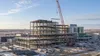 Steel framing and a crane at a modern hospital construction site on the North Dakota prairie.