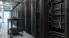 Unbranded server racks and a plain equipment cart in a naturally lit modern data center