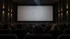 Audience seated in an unbranded cinema auditorium before a documentary screening