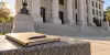 Generic Oklahoma courthouse steps with an unlabeled legal folder and pen