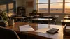 Empty Oklahoma classroom with retirement paperwork and a calculator on a teacher's desk