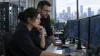 Software security engineers review package-registry activity in a network operations workspace.