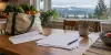 Blank benefit paperwork, an envelope and groceries on a kitchen table in an Oregon home.