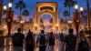 Editorial image of visitors approaching a generic Central Florida theme-park entrance during Halloween season