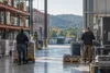 Illustrative view of two workers in an unbranded Pennsylvania logistics and light-manufacturing facility