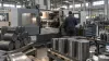 A plant technician monitoring precision metal machining in an unbranded industrial facility