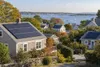 Rooftop solar panels on coastal New England homes overlooking Narragansett Bay
