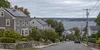 Solar panels on rooftops in a Rhode Island residential neighborhood under an overcast sky