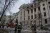 Emergency responders outside a damaged neoclassical building in Kyiv after a drone strike