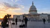 News cameras stand outside the U.S. Capitol before a major Senate vote.