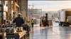 Illustrative South Carolina labor-market scene with anonymous workers across manufacturing, logistics and construction