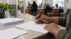 A voter completes a registration form at a county public-service counter.