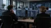 Cybersecurity analysts monitor unbranded workstations in a neutral security operations center.
