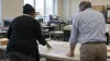 Election workers reviewing an unmarked congressional district map in a Missouri county office