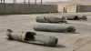 Representative view of unmarked inert aerial-bomb casings in a secure industrial dismantlement yard
