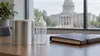 Unbranded infant formula container, baby bottle and legal folder on an office table